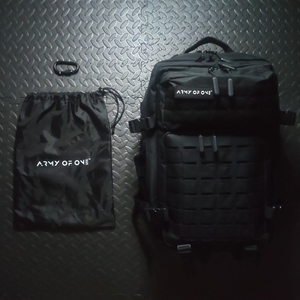 BLACK DRAWSTRING BAG LAYING BESIDE BLACK 45 LITRE BACKPACK